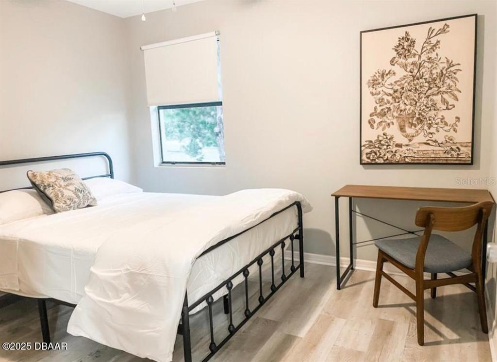 404 South Ridgewood Avenue Daytona Beach, FL 32114 - Photo 51 of 53 a bedroom with a bed and chair