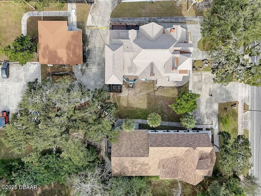 404 South Ridgewood Avenue Daytona Beach, FL 32114 - Photo 7 of 53 an aerial view of a house with a yard and large trees