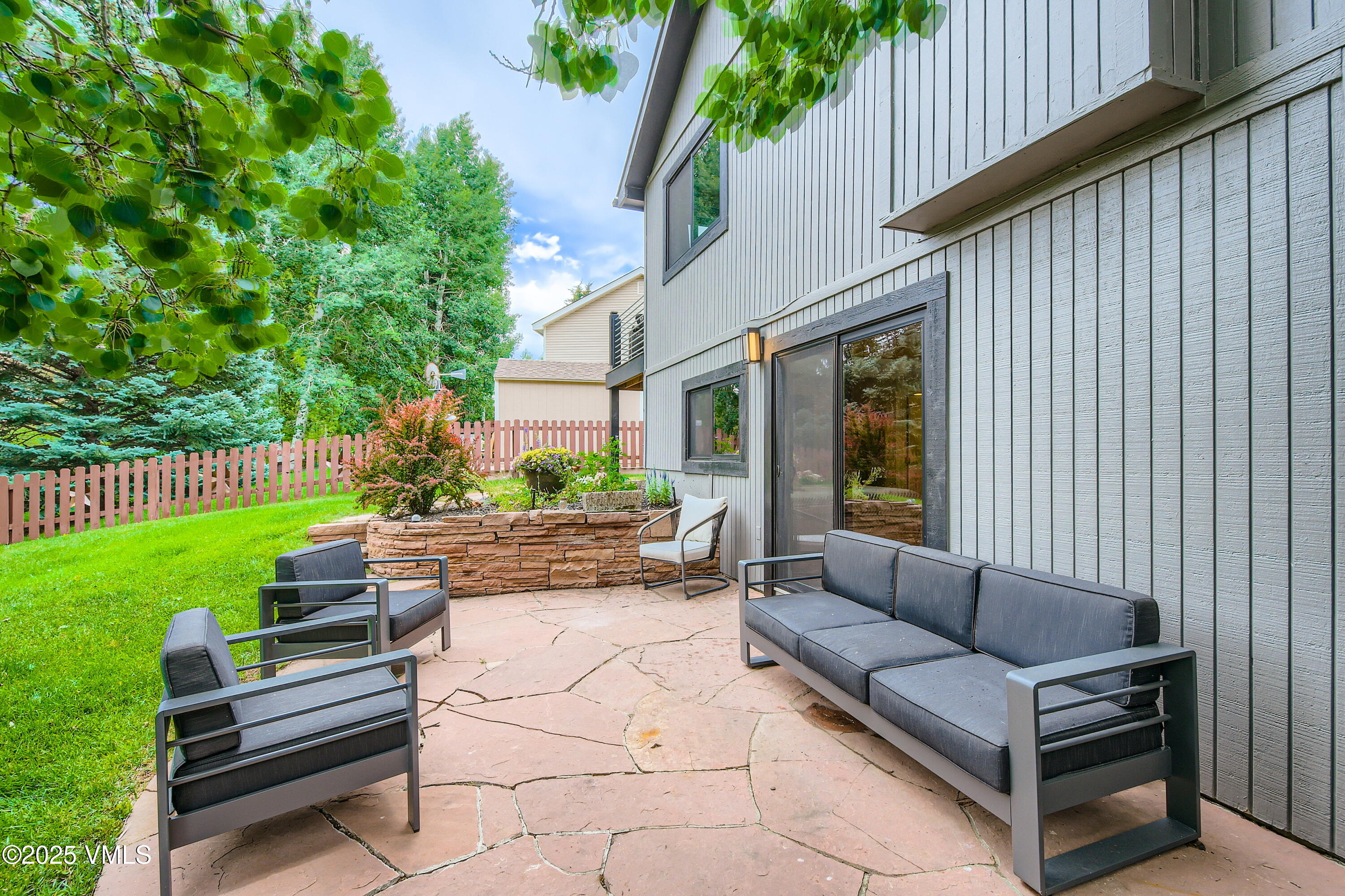 11 Spruce Circle Edwards, CO 81632 - Photo 11 of 27 a view of a backyard with couches potted plants and wooden fence