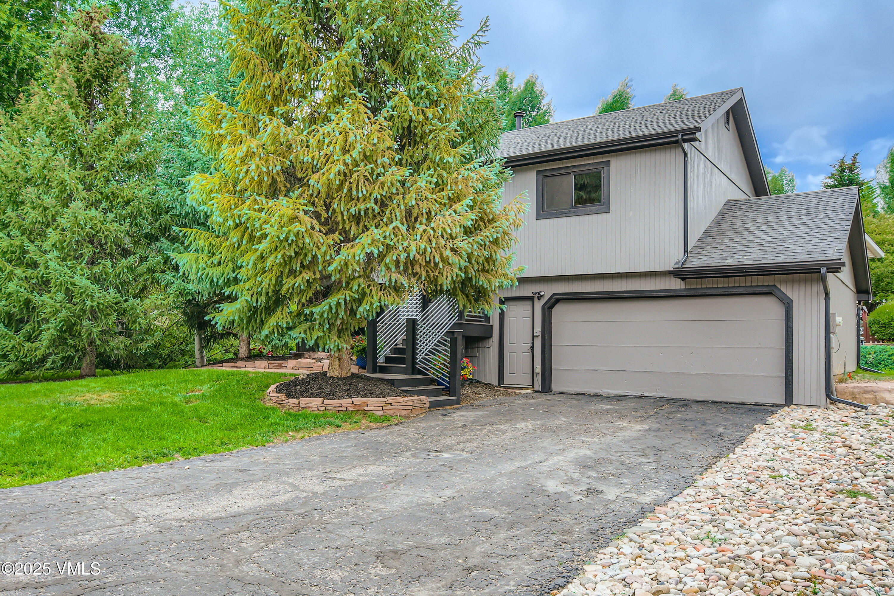 11 Spruce Circle Edwards, CO 81632 - Photo 23 of 27 a house with a yard and garage