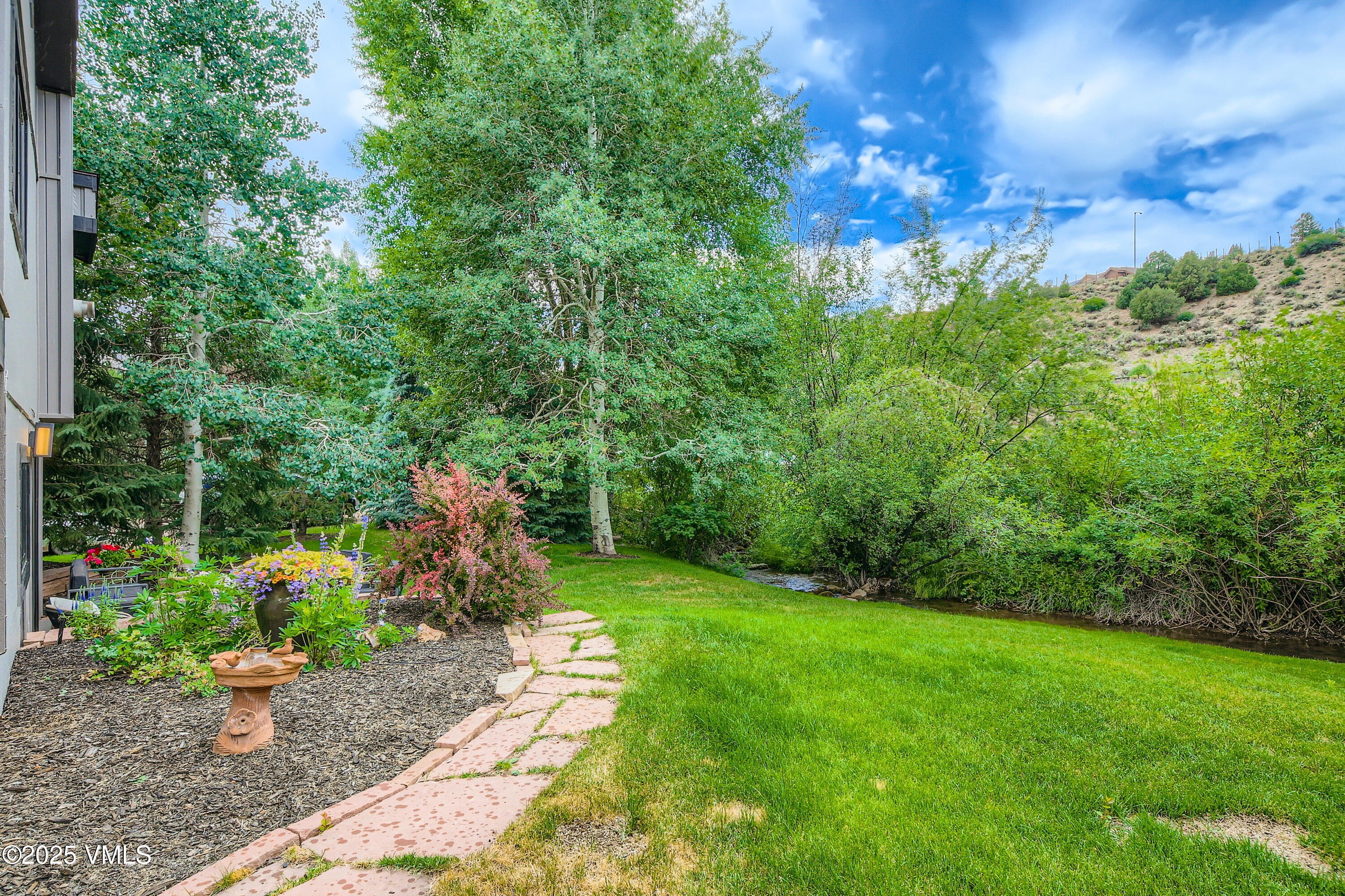11 Spruce Circle Edwards, CO 81632 - Photo 26 of 27 a view of a backyard with plants and a fountain