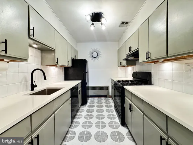a kitchen with a sink a stove and cabinets