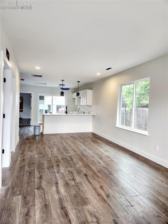 704 Elm Street Pueblo, CO 81004 - Photo 4 of 22 a large room with kitchen view and living room view
