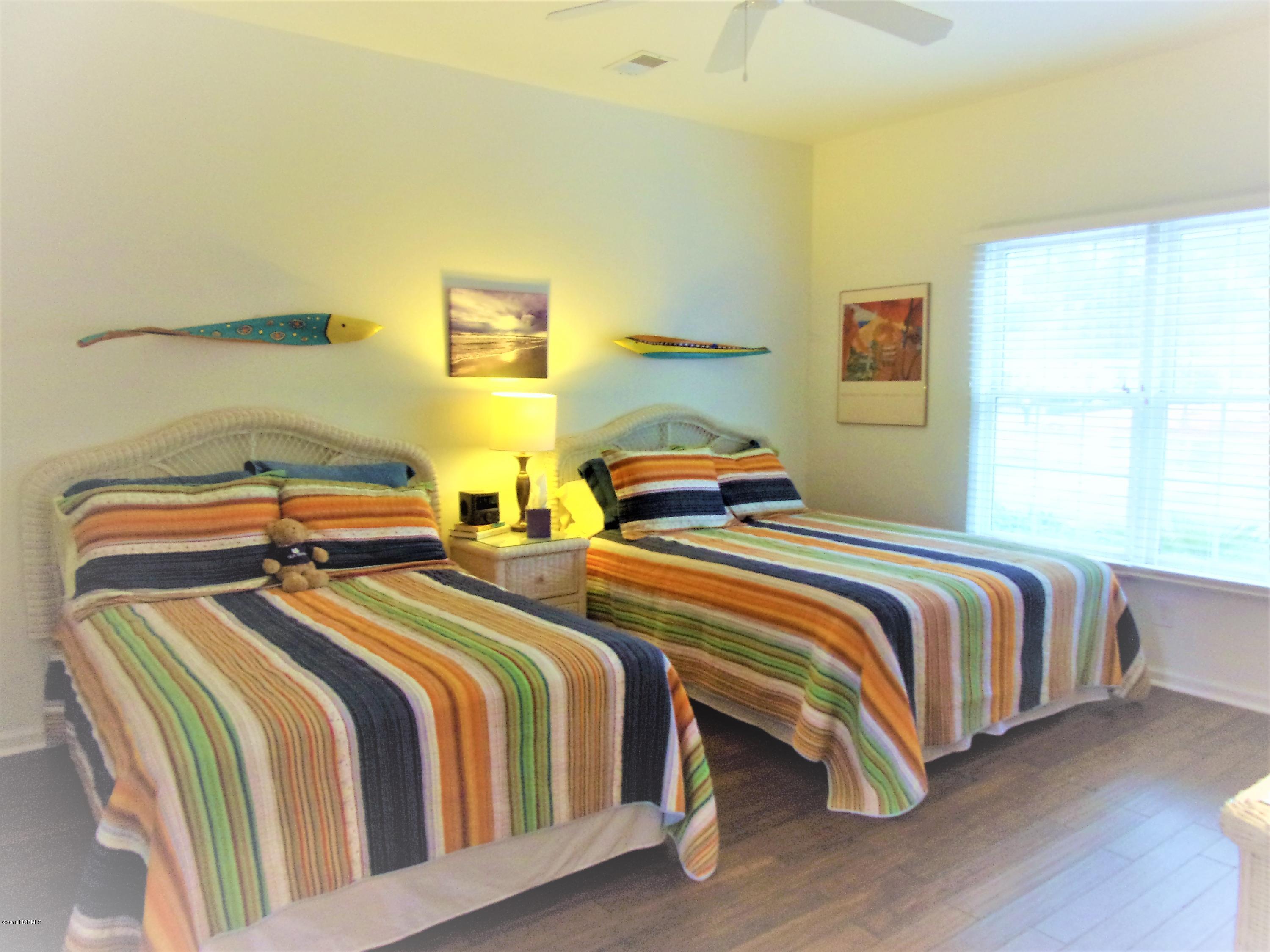 116 Rice Mill Circle, Unit 1 Sunset Beach, NC 28468 - Photo 15 of 24 guest bedroom with bamboo flooring