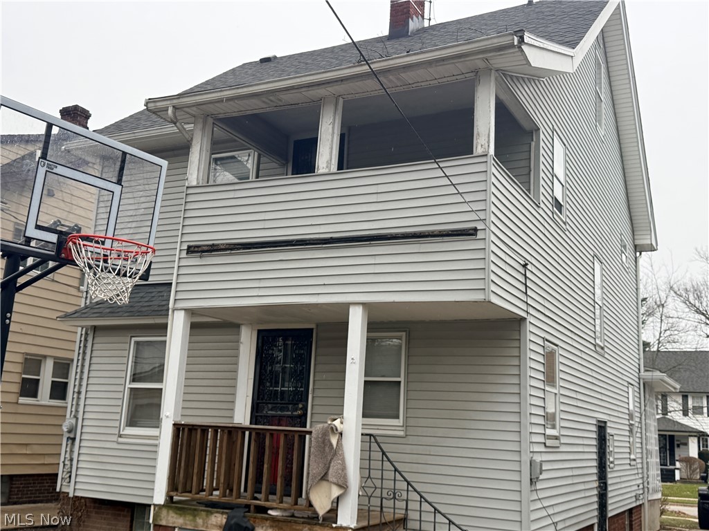 980 Brunswick Road Cleveland Heights, OH 44112 - Photo 3 of 11 View of property exterior featuring roof with shingles, a balcony, a chimney, and covered porch