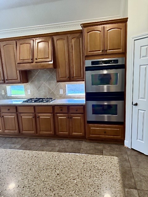 1810 Rippling Water Court Sugar Land, TX 77479 - Photo 13 of 37 Windows above the countertop supply additional natural light while cooking on the gas cooktop.