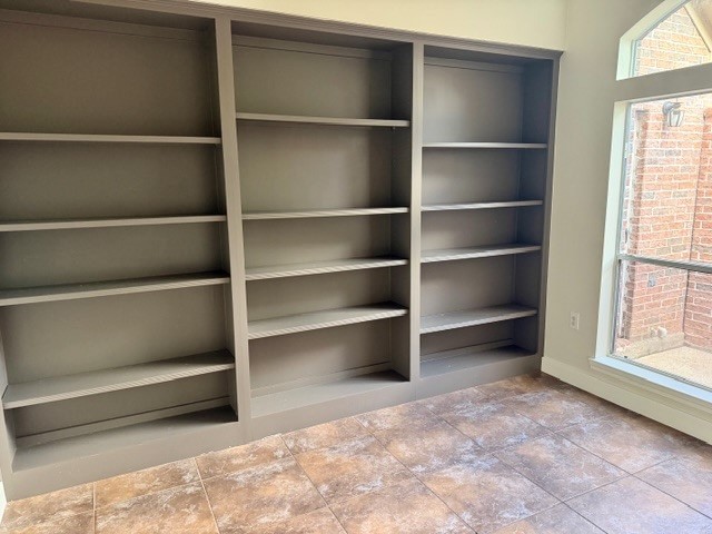1810 Rippling Water Court Sugar Land, TX 77479 - Photo 20 of 37 Huge amount of shelving in the office/flex room. The atrium is on the right.