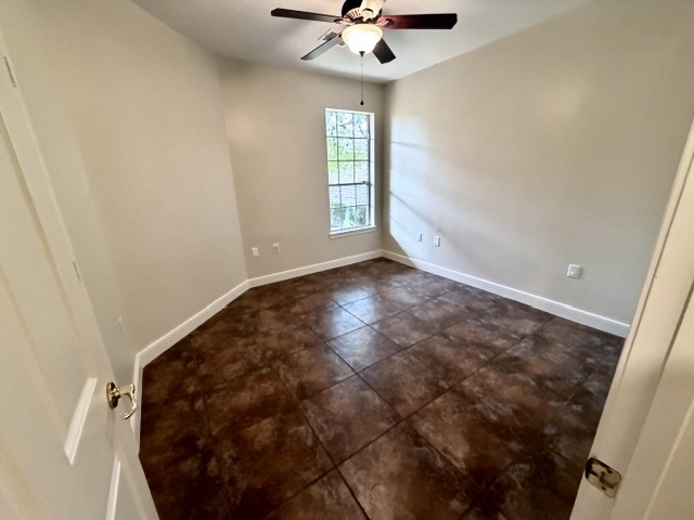 1810 Rippling Water Court Sugar Land, TX 77479 - Photo 31 of 37 Tiled secondary bedroom with lighted ceiling fan.