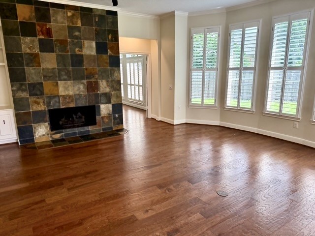 1810 Rippling Water Court Sugar Land, TX 77479 - Photo 4 of 37 Family room with lots of natural light shows the beauty of the hardwood flooring and the tiled surround fireplace gives the room a special ambiance.