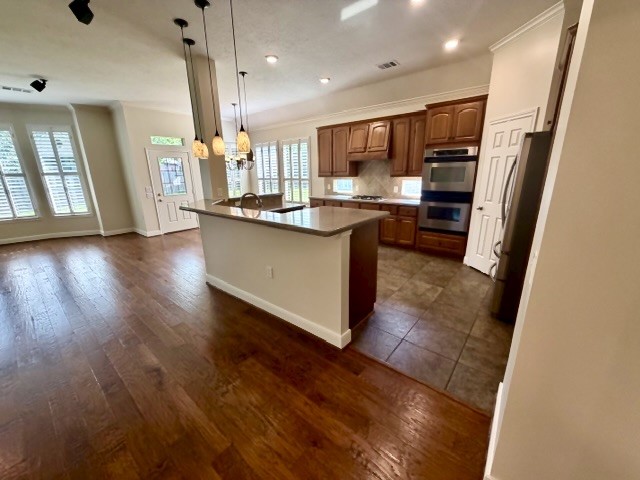 1810 Rippling Water Court Sugar Land, TX 77479 - Photo 8 of 37 Love the openness from the living area to the kitchen and breakfast area. Extensive hardwood flooring and tile are throughout the home.