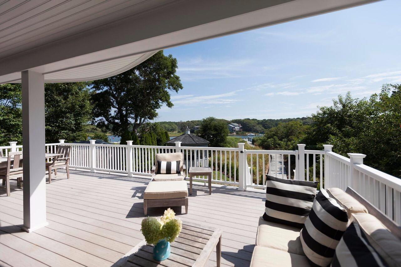 a view of balcony with wooden floor and outdoor seating