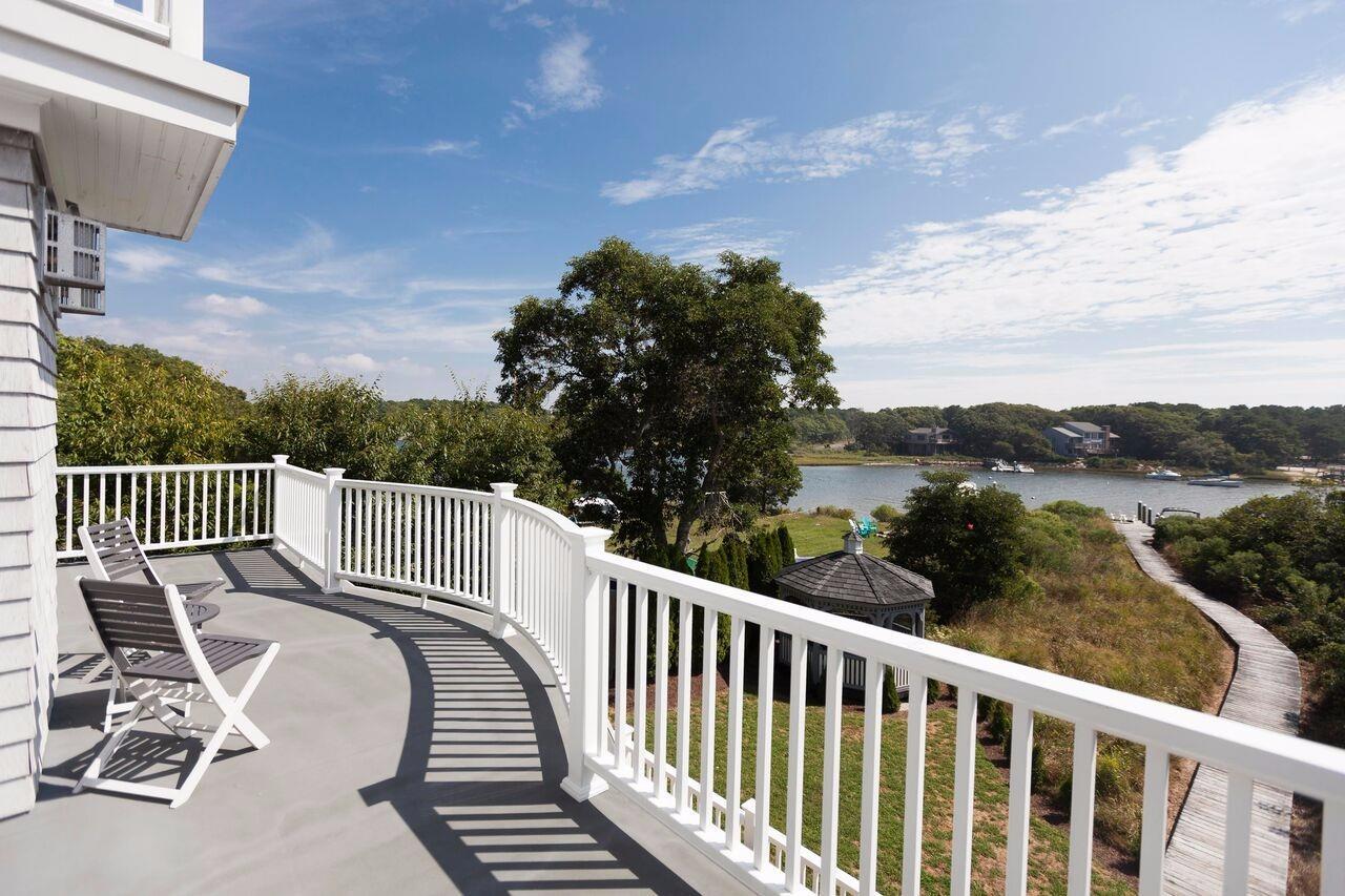 374 Monomoscoy Road Mashpee, MA 02649 - Photo 12 of 29 a view of a chair and tables in the balcony