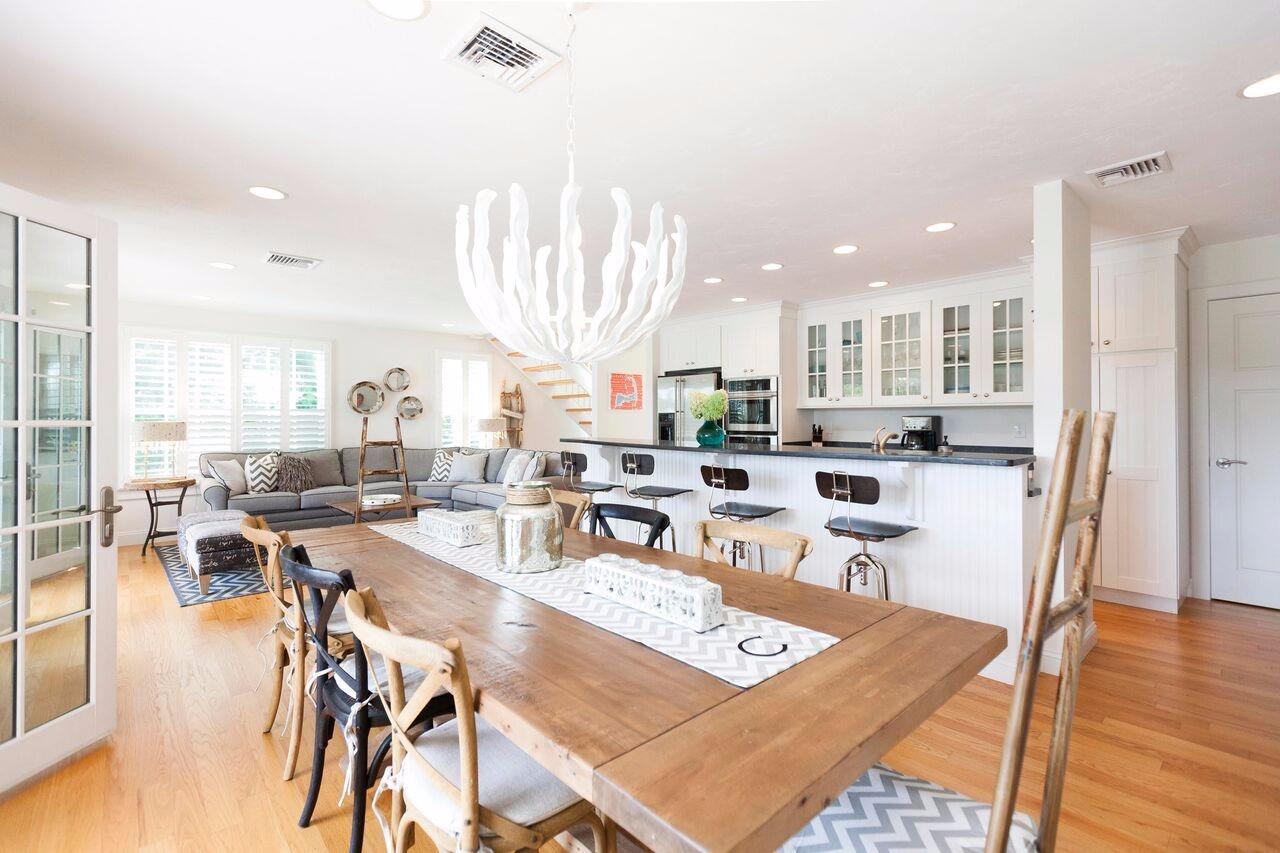 374 Monomoscoy Road Mashpee, MA 02649 - Photo 16 of 29 a large kitchen with a large counter top appliances and a dining table