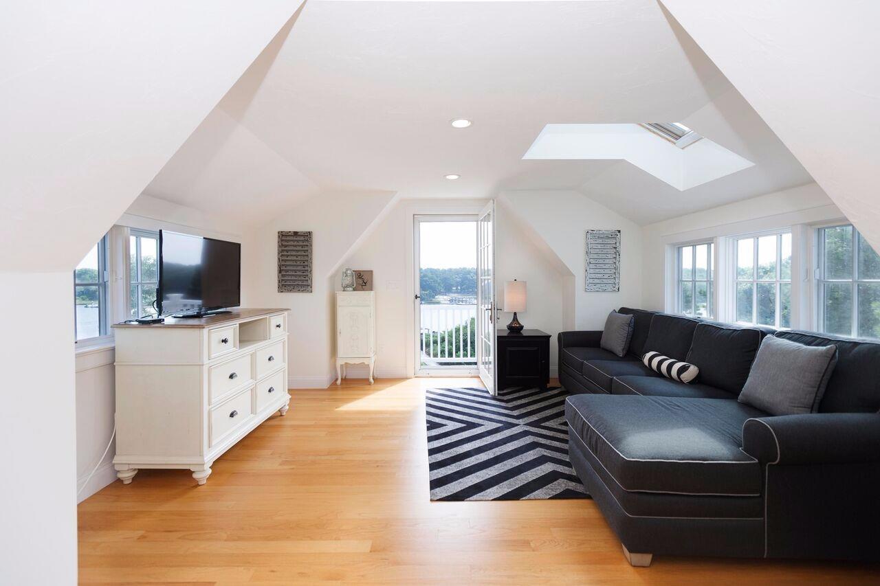 374 Monomoscoy Road Mashpee, MA 02649 - Photo 17 of 29 a living room with furniture and a flat screen tv