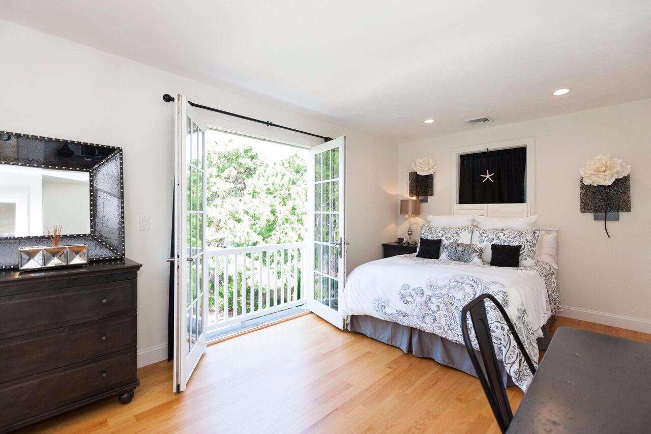 374 Monomoscoy Road Mashpee, MA 02649 - Photo 24 of 29 a bedroom with a bed and a flat screen tv