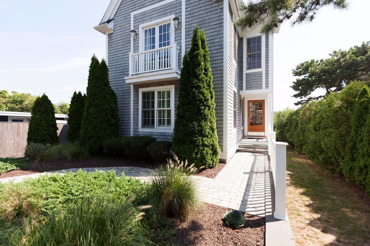 374 Monomoscoy Road Mashpee, MA 02649 - Photo 6 of 29 a front view of a house with a yard