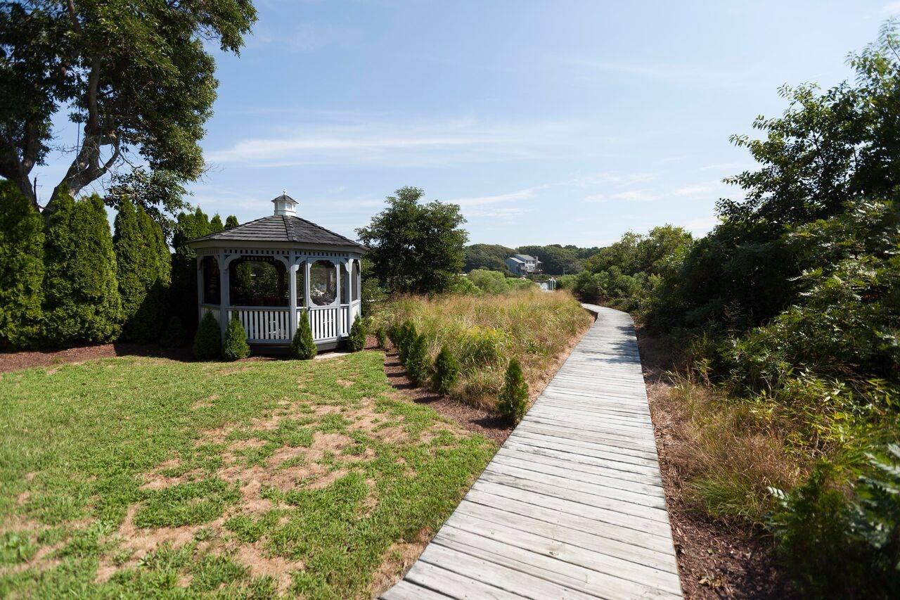 374 Monomoscoy Road Mashpee, MA 02649 - Photo 8 of 29 a front view of a house with a yard
