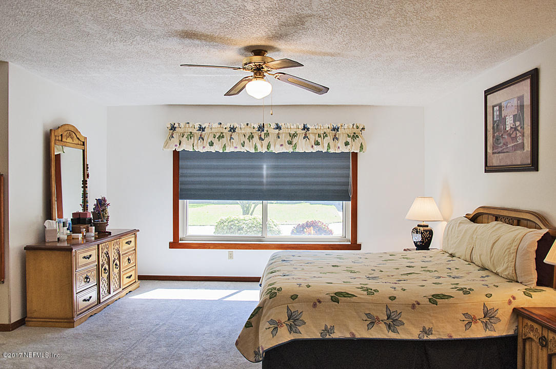 145 Tanager Road St. Augustine, FL 32086 - Photo 15 of 43 a bedroom with a bed and ceiling fan