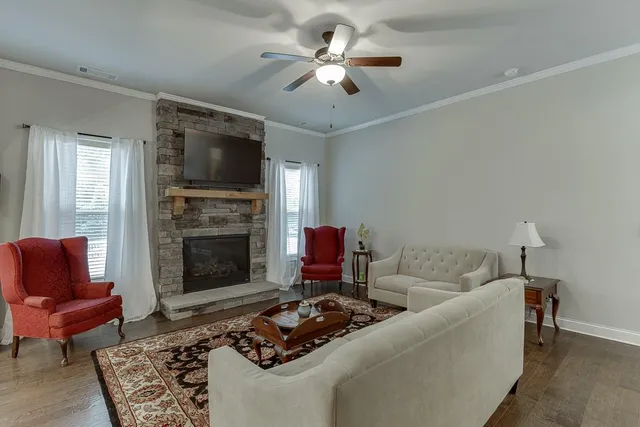 a living room with furniture and a dining table