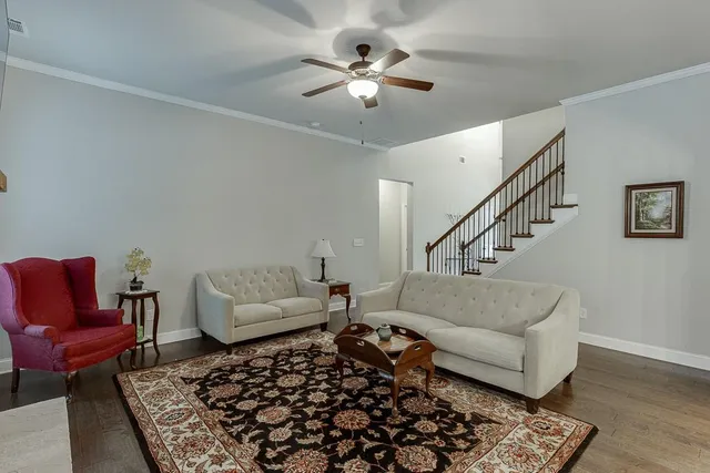 a kitchen with stainless steel appliances kitchen island granite countertop a stove a refrigerator a kitchen island a dining table and chairs