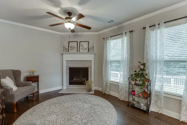 a bedroom with a large bed and a chandelier fan