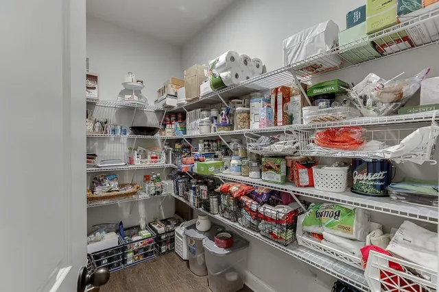 a bathroom with a granite countertop sink a toilet a shower and a mirror