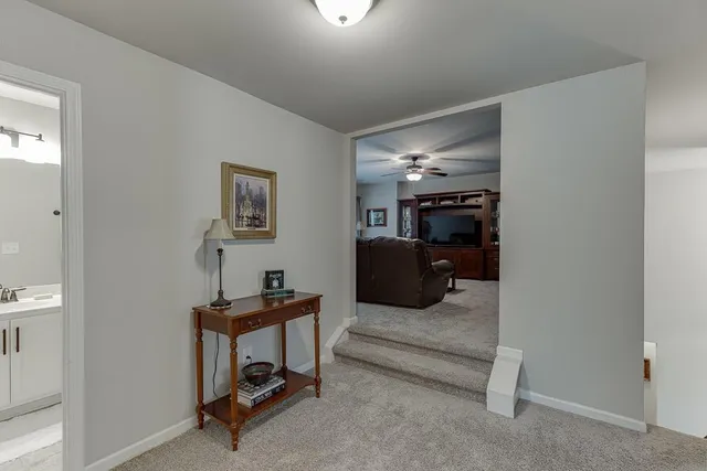 a bathroom with a sink vanity mirror and toilet