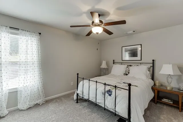 a view of backyard with a table and chairs with wooden fence