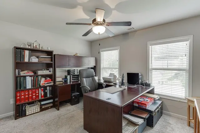 an aerial view of a house with swimming pool and garden space