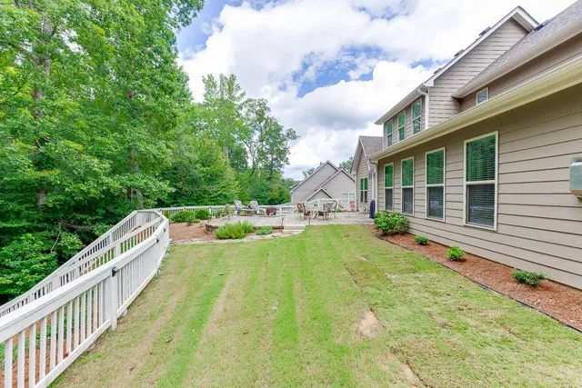 an aerial view of a house with a yard and lake view