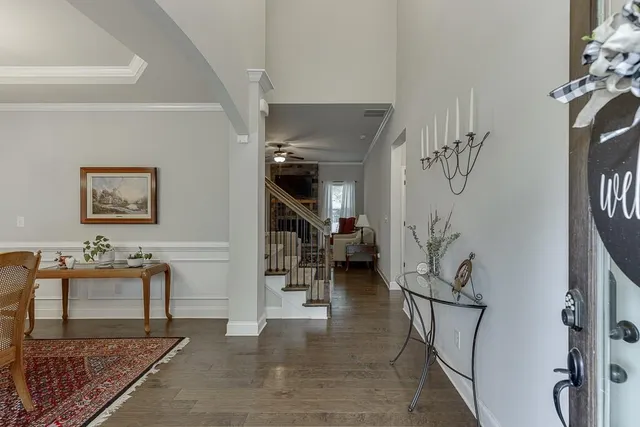 a dining room with furniture a chandelier and window