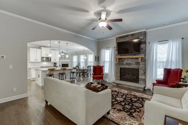 a living room with furniture and a fireplace