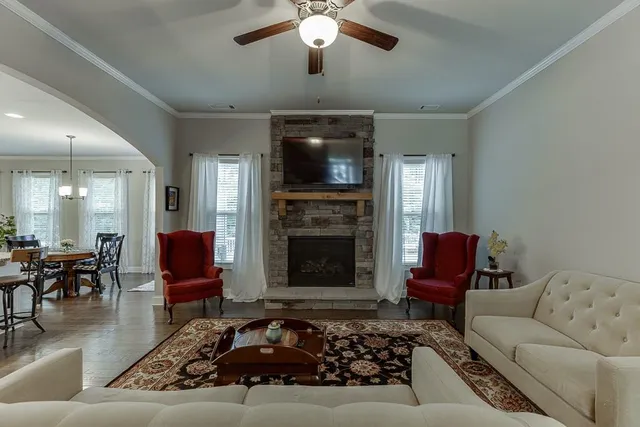a living room with furniture and a fireplace