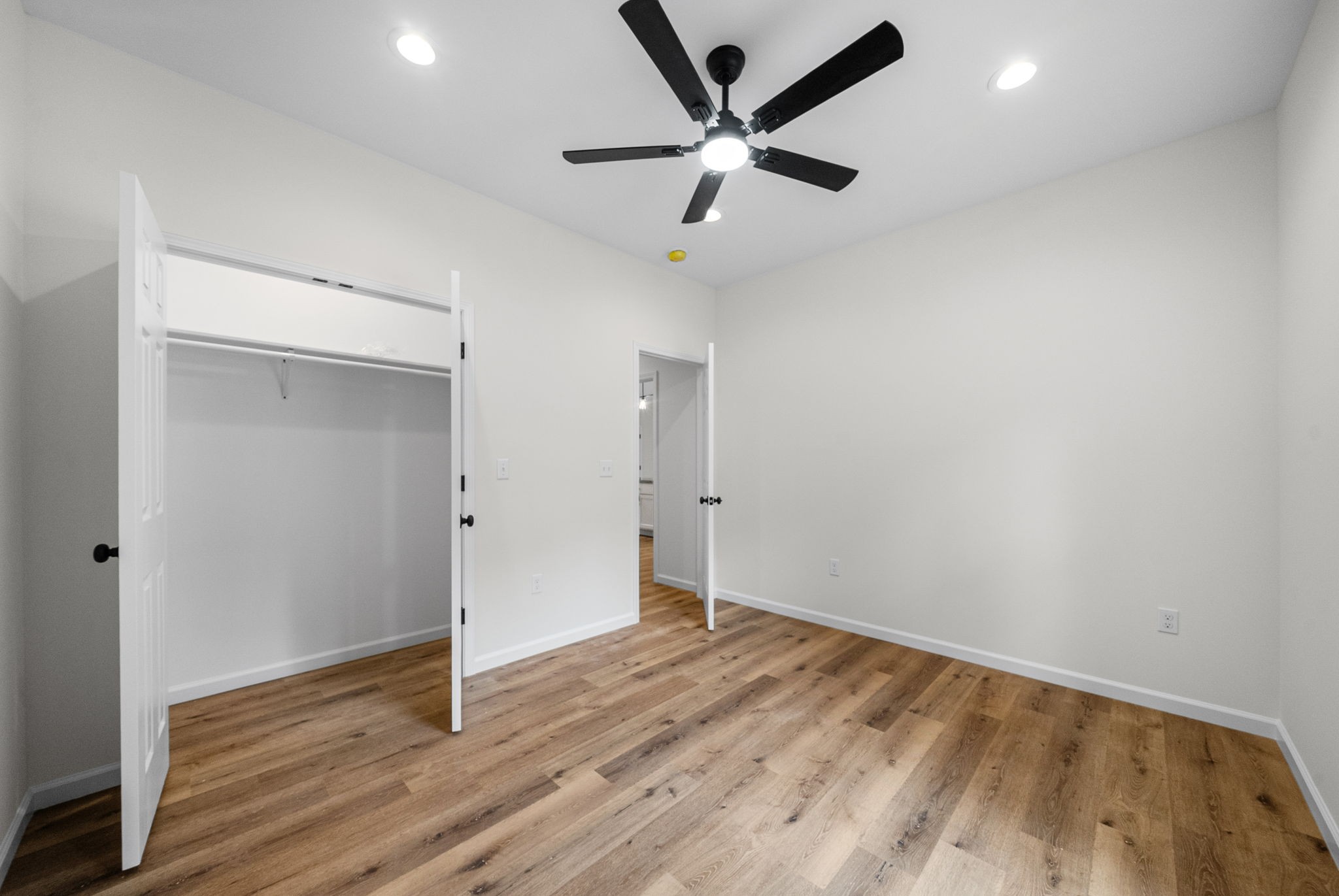 690 Brazzle Road Waverly, TN 37185 - Photo 26 of 35 an empty room with wooden floor and windows