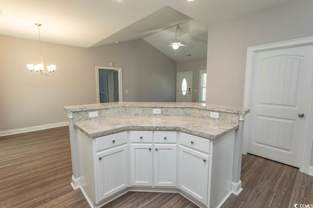 126 Allsbrook Road Loris, SC 29569 - Photo 12 of 30 Kitchen featuring white cabinetry, light countertops, lofted ceiling, and dark wood-style floors