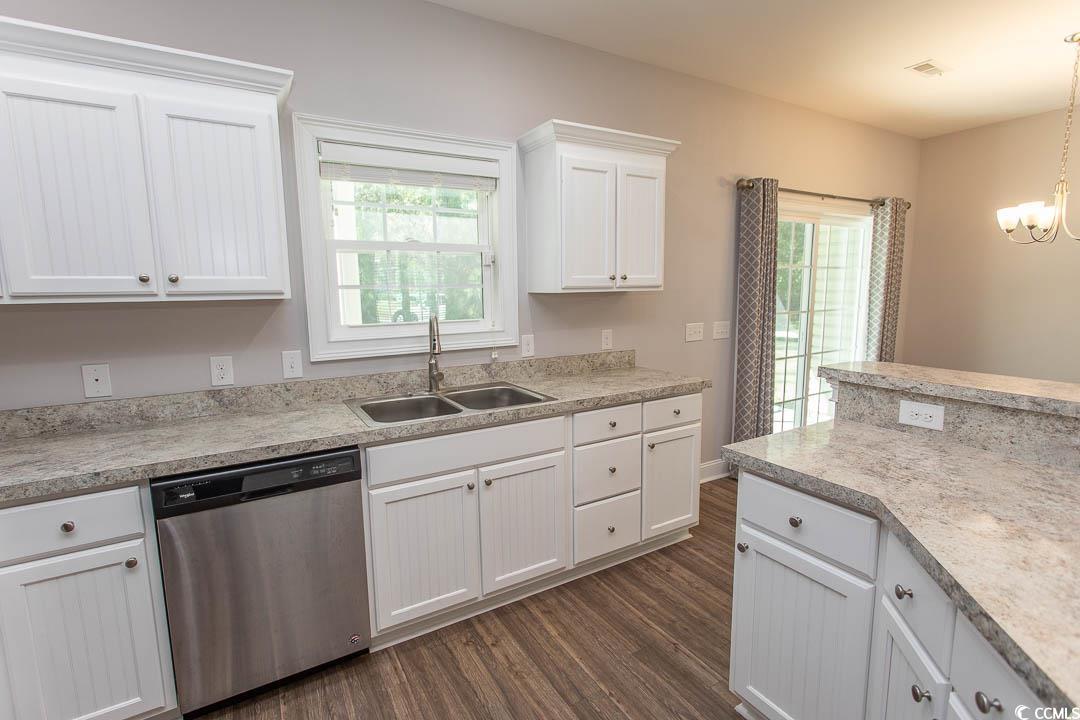 126 Allsbrook Road Loris, SC 29569 - Photo 13 of 30 Kitchen with white cabinets, dishwasher, light countertops, dark wood-style floors, and a chandelier