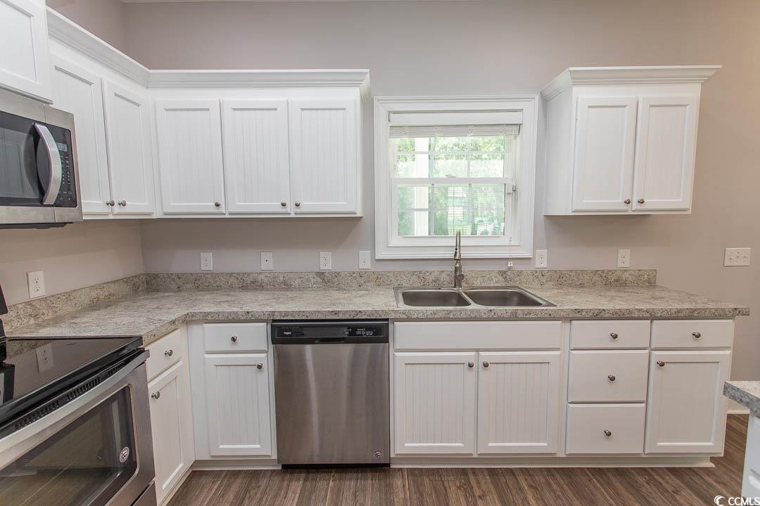 126 Allsbrook Road Loris, SC 29569 - Photo 14 of 30 Kitchen with appliances with stainless steel finishes, white cabinetry, and light countertops
