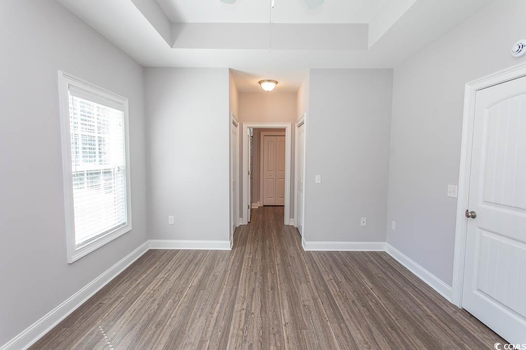 126 Allsbrook Road Loris, SC 29569 - Photo 16 of 30 Unfurnished room featuring dark wood finished floors, a tray ceiling, a smoke detector, and ceiling fan