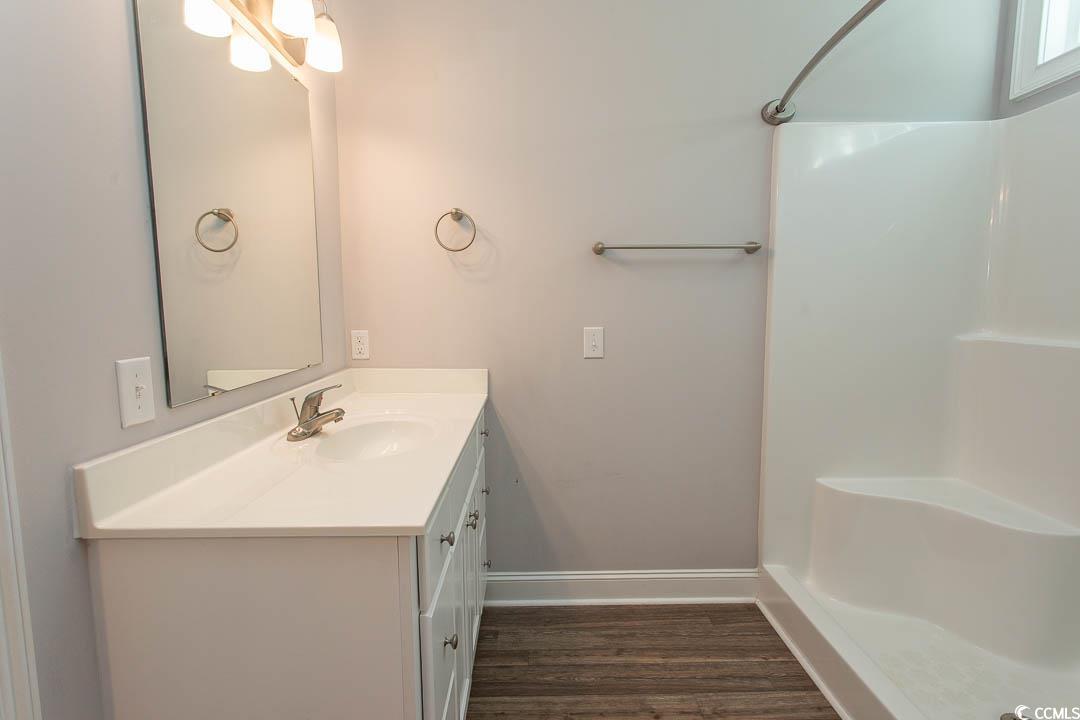 126 Allsbrook Road Loris, SC 29569 - Photo 20 of 30 Bathroom with vanity, a stall shower, and dark wood-style flooring