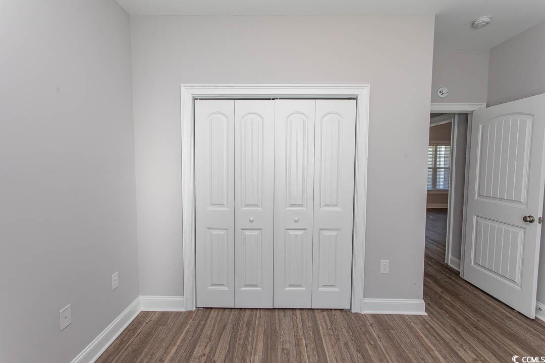 126 Allsbrook Road Loris, SC 29569 - Photo 27 of 30 Unfurnished bedroom with dark wood-style floors and a closet