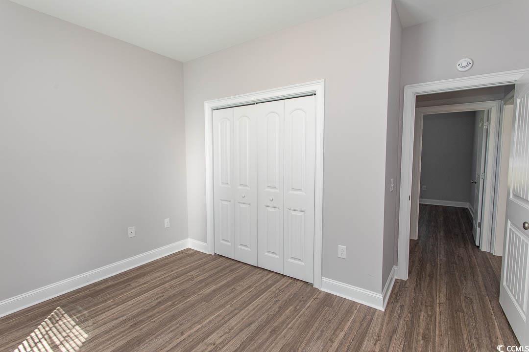 126 Allsbrook Road Loris, SC 29569 - Photo 28 of 30 Unfurnished bedroom with dark wood-style floors and a closet