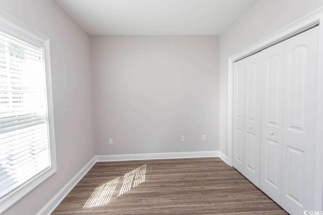 126 Allsbrook Road Loris, SC 29569 - Photo 29 of 30 Unfurnished bedroom with dark wood finished floors and a closet