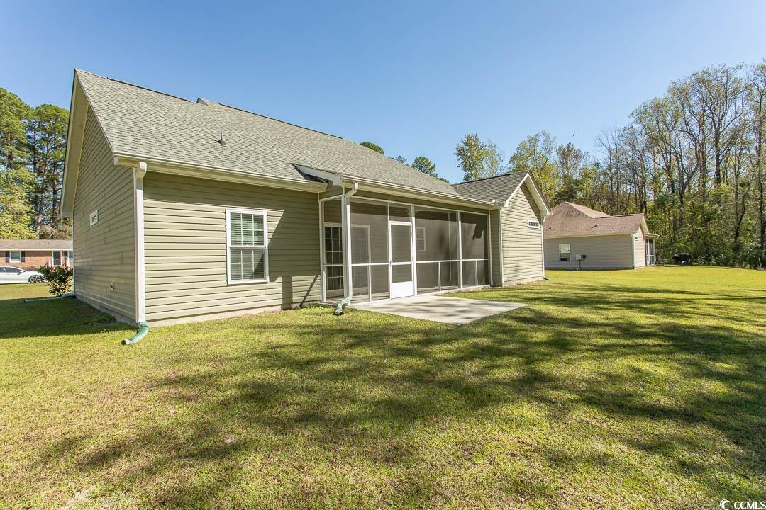 126 Allsbrook Road Loris, SC 29569 - Photo 4 of 30 Back of house with a yard, a sunroom, and roof with shingles