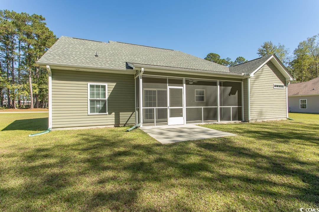 126 Allsbrook Road Loris, SC 29569 - Photo 5 of 30 Rear view of house with a lawn, roof with shingles, and a sunroom