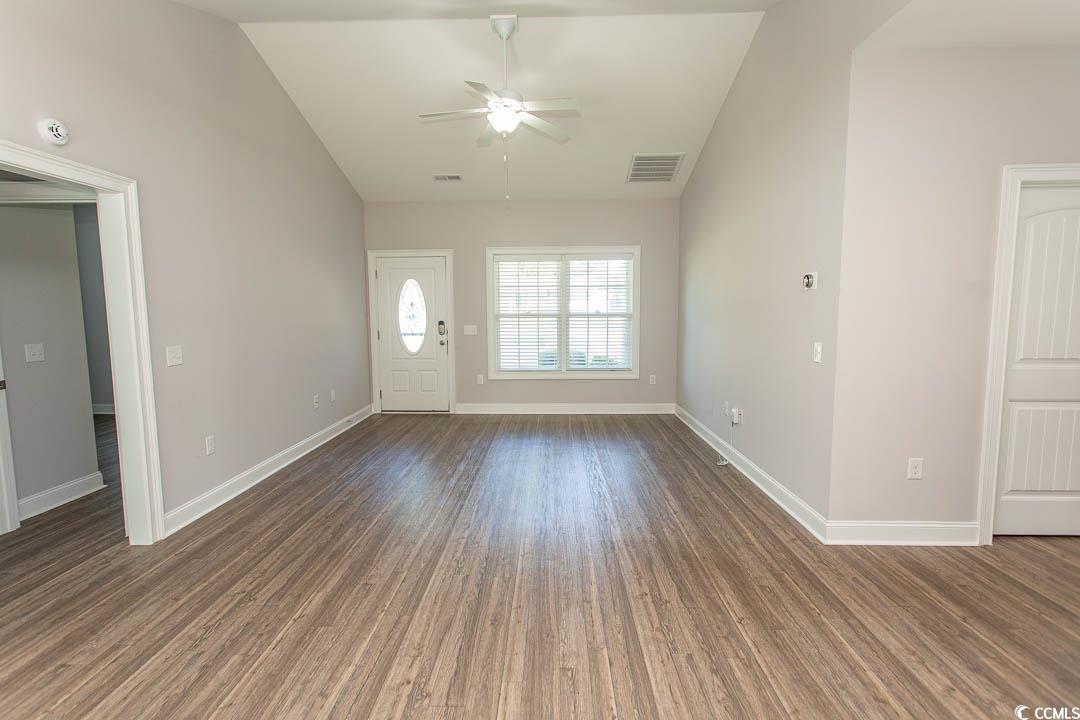 126 Allsbrook Road Loris, SC 29569 - Photo 8 of 30 Unfurnished living room featuring vaulted ceiling, wood finished floors, and a ceiling fan