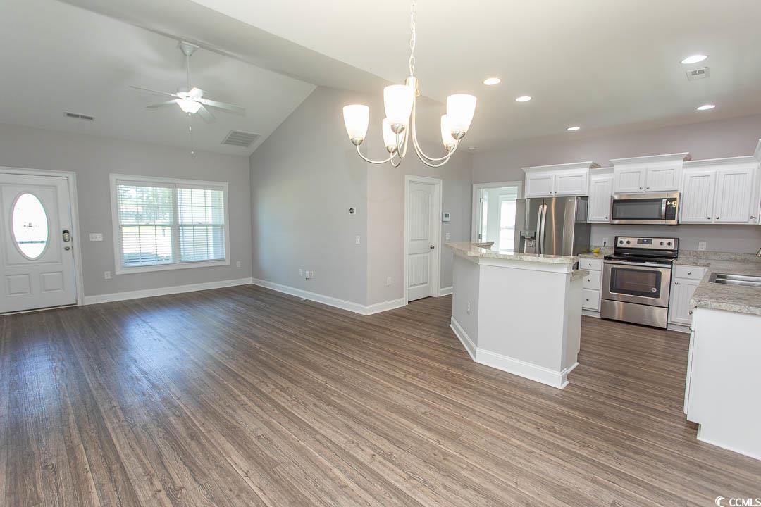 126 Allsbrook Road Loris, SC 29569 - Photo 30 of 30 Kitchen with pendant lighting, stainless steel appliances, a chandelier, white cabinetry, and open floor plan