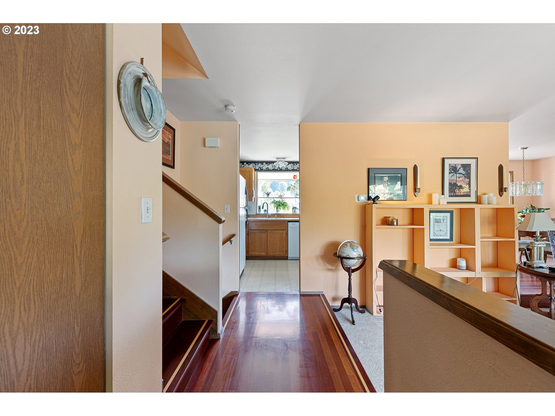 889 South 45th Place Springfield, OR 97478 - Photo 5 of 28 a hallway with a large mirror and cabinets