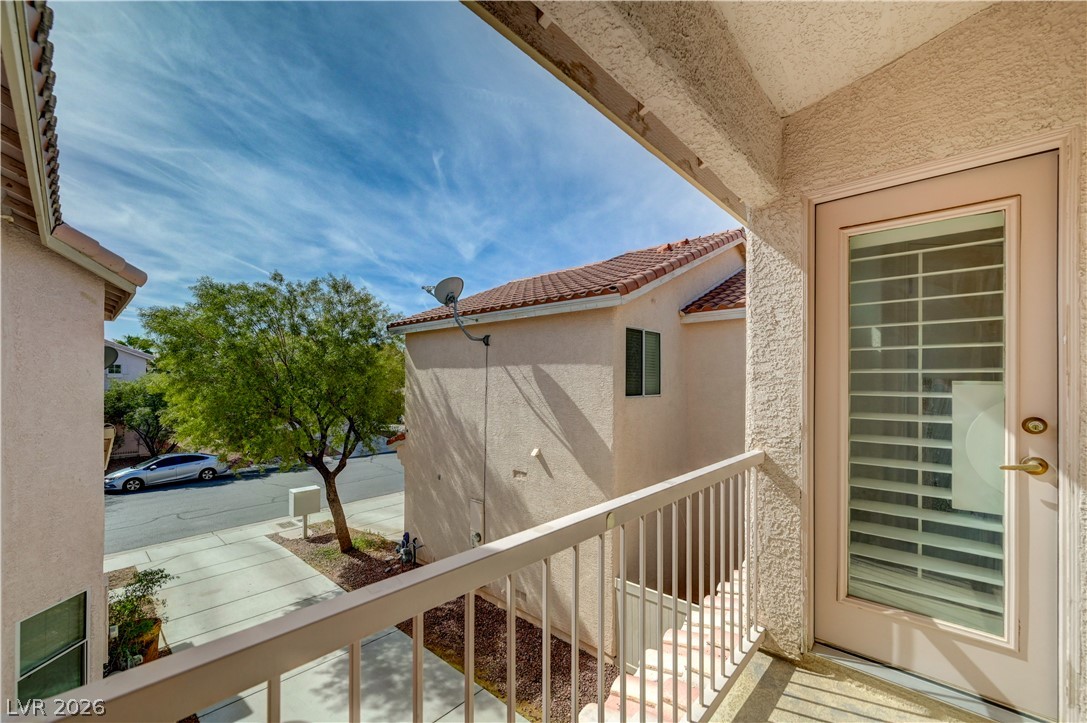 8918 Houston Ridge Avenue Las Vegas, NV 89178 - Photo 18 of 35 Step onto the private balcony and enjoy the vibrant neighborhood street views.