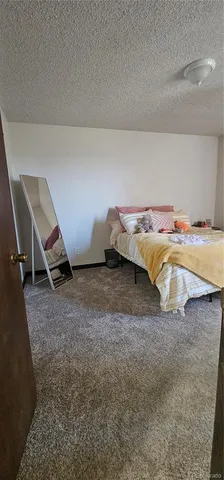 a bed sitting in a room next to a window