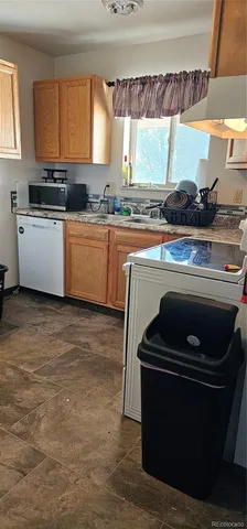 a kitchen with a stove a sink and a microwave